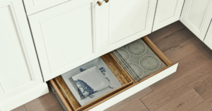Toe-kick drawer in a mobile home kitchen remodel providing hidden storage and maximizing space efficiency.